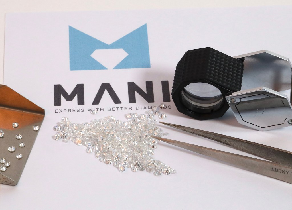 Certified melee diamonds with loupe and tweezers at the Mani grading desk